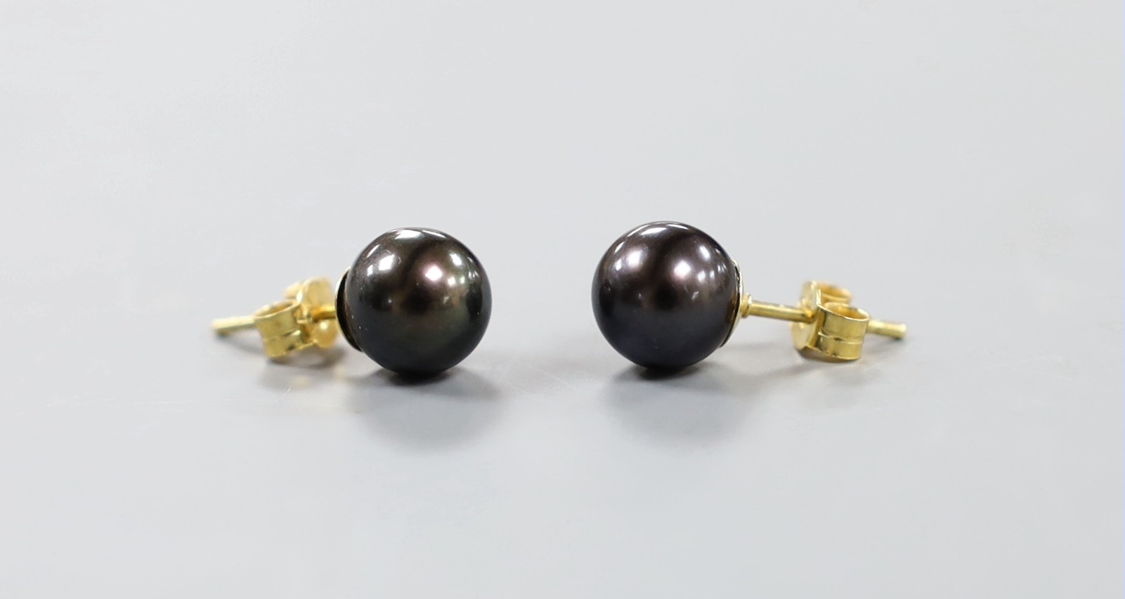 A pair of 18ct and cultured Tahitian pearl set ear studs.